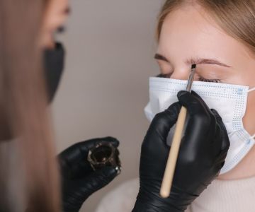 бровист красит брови клиентке